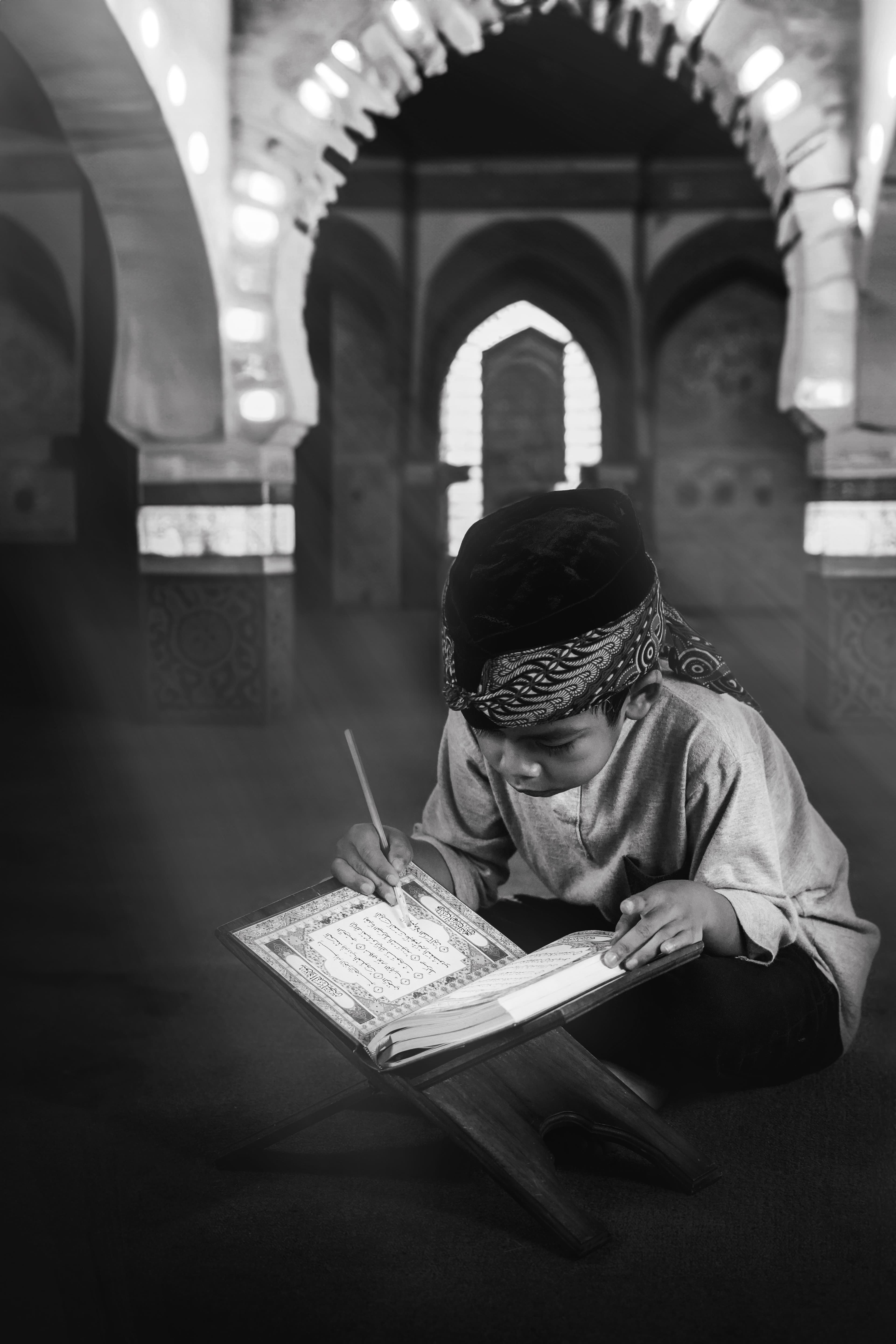 A student writing during Islamic studies inside a mosque