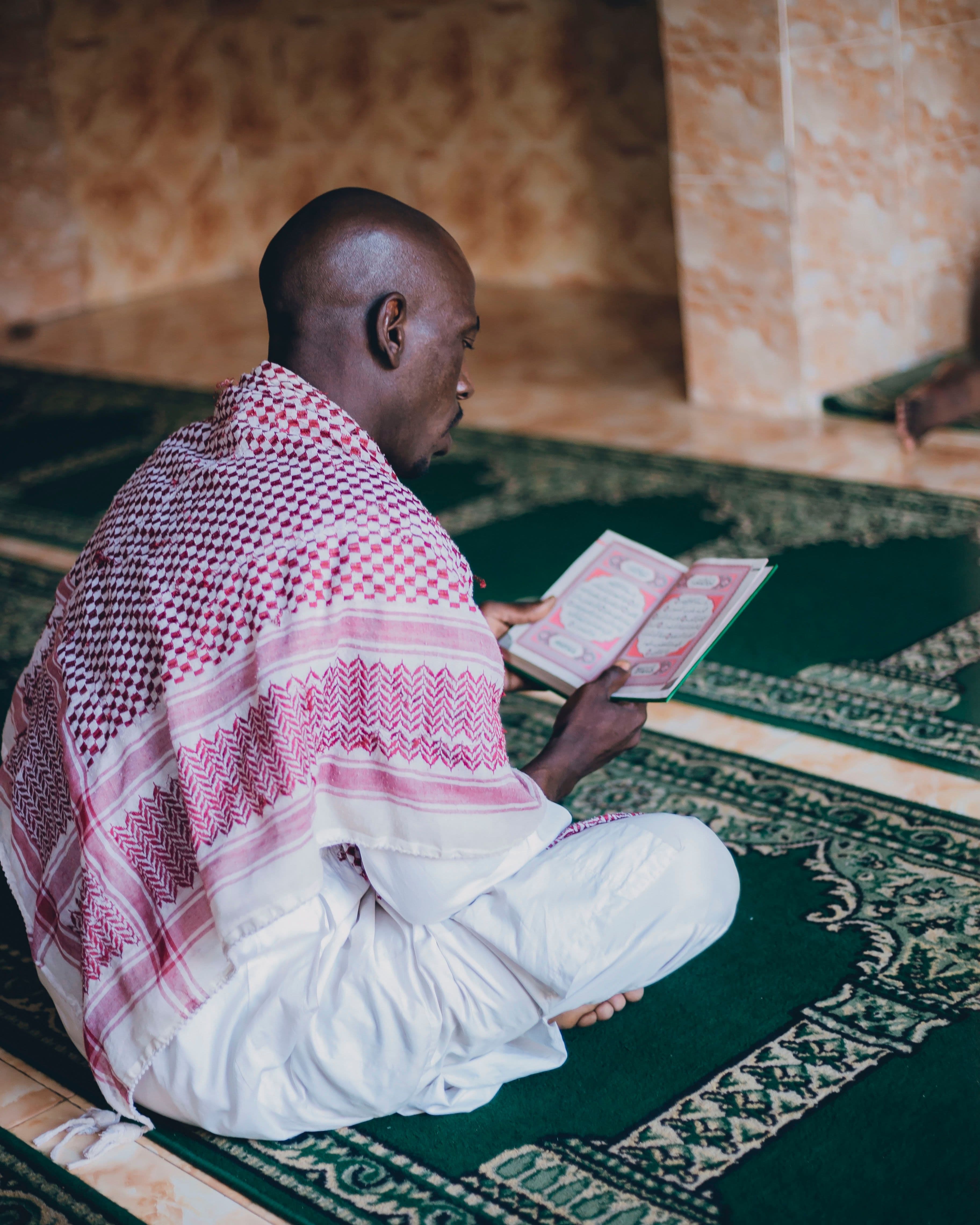 An adult student reading the Quran during a focused study session