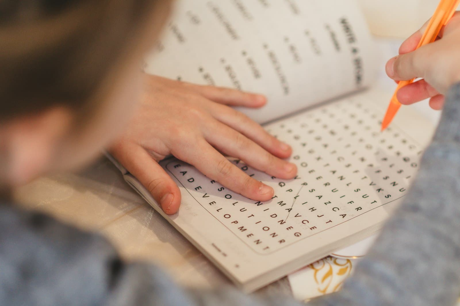 A child writing during a quiet study session at home